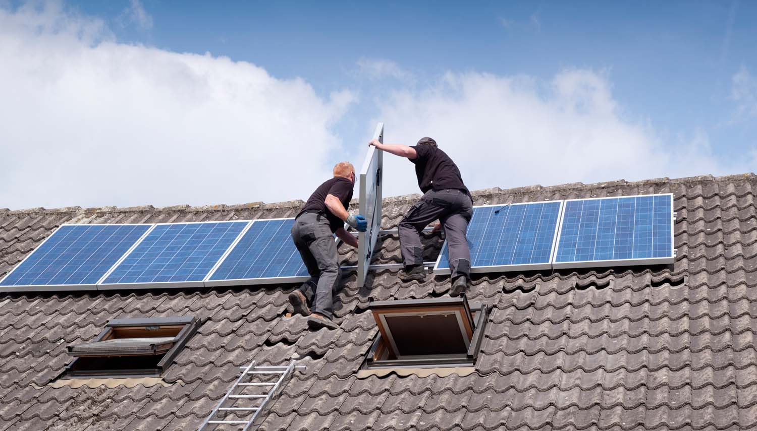 workers on a roof are installing solar panels in san antonio tx