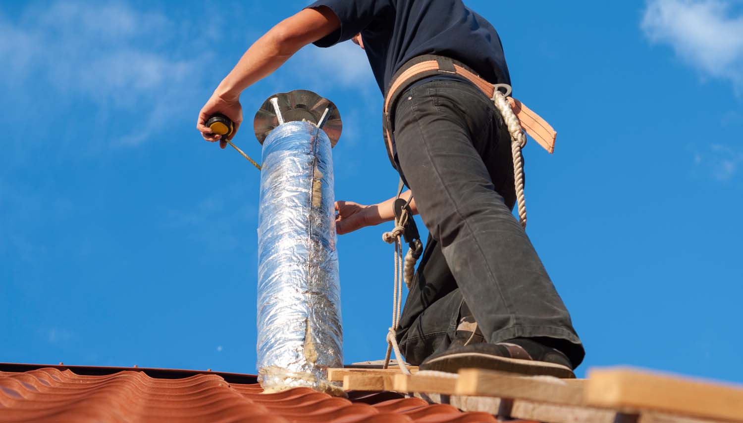 close up view of a contractor adding attic ventilation to a roof