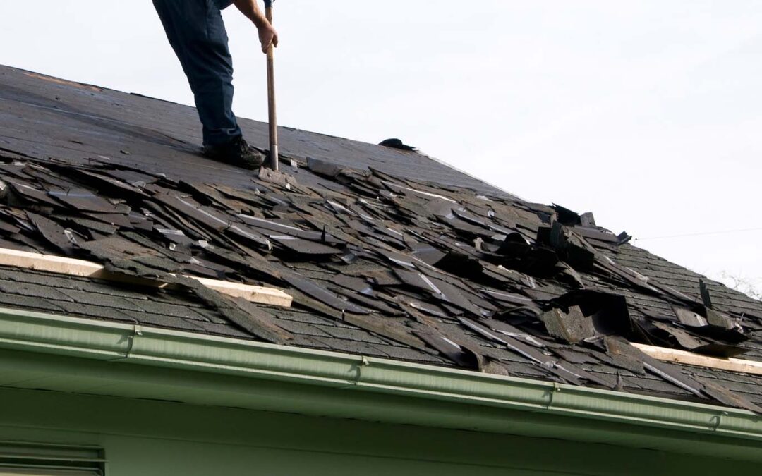 contractor working on repairing a roof after it has been damaged by the storm
