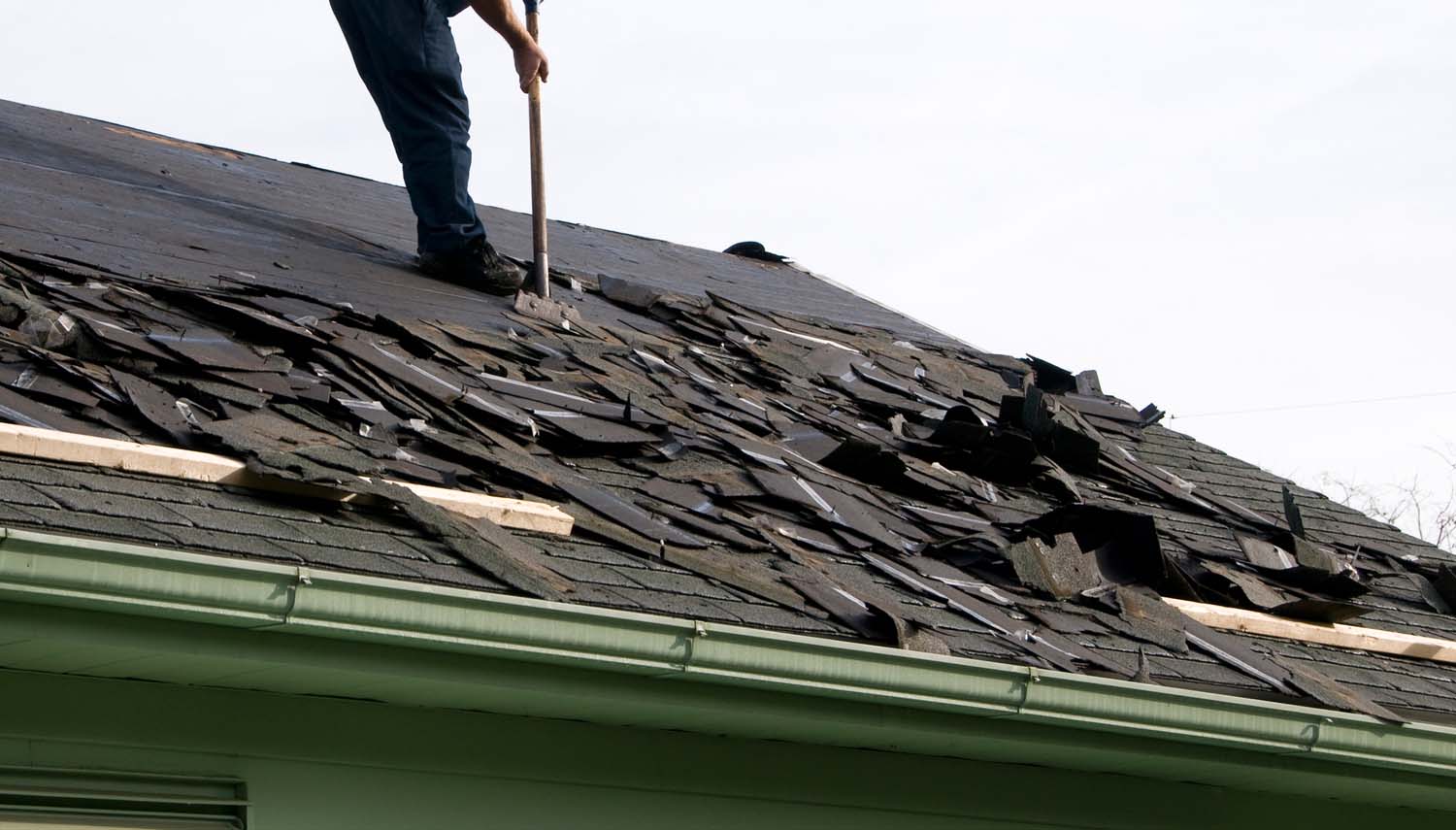 contractor working on repairing a roof after it has been damaged in san antonio