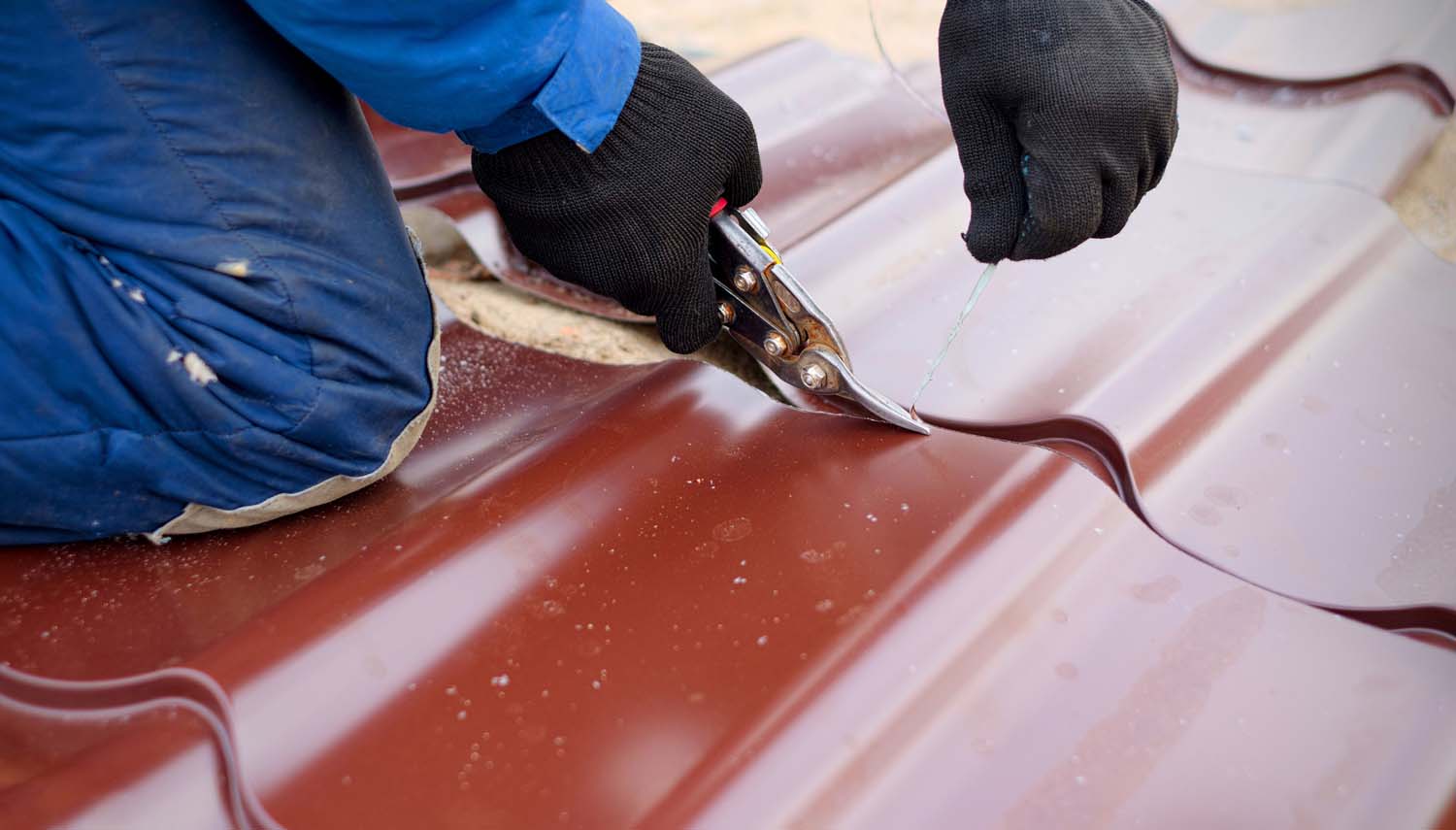 close up of a roofing contractor repairing a metal roof near San Antonio, TX
