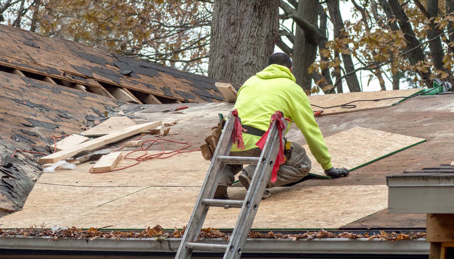 roofing contractor working on replacing roof shingles after a storm in san antonio