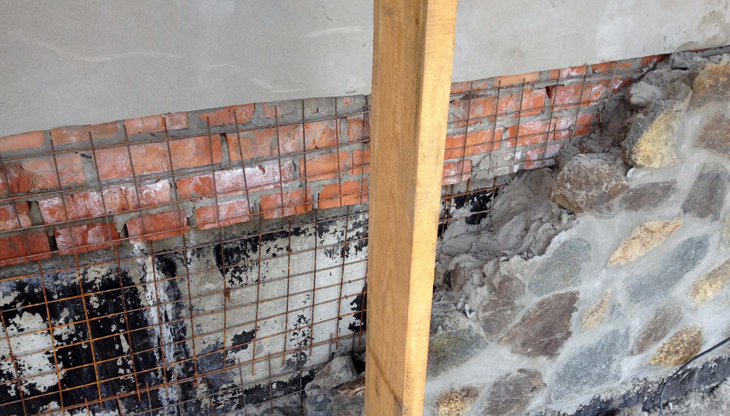 foundation of a home is ready for repair bricks and framing shown here