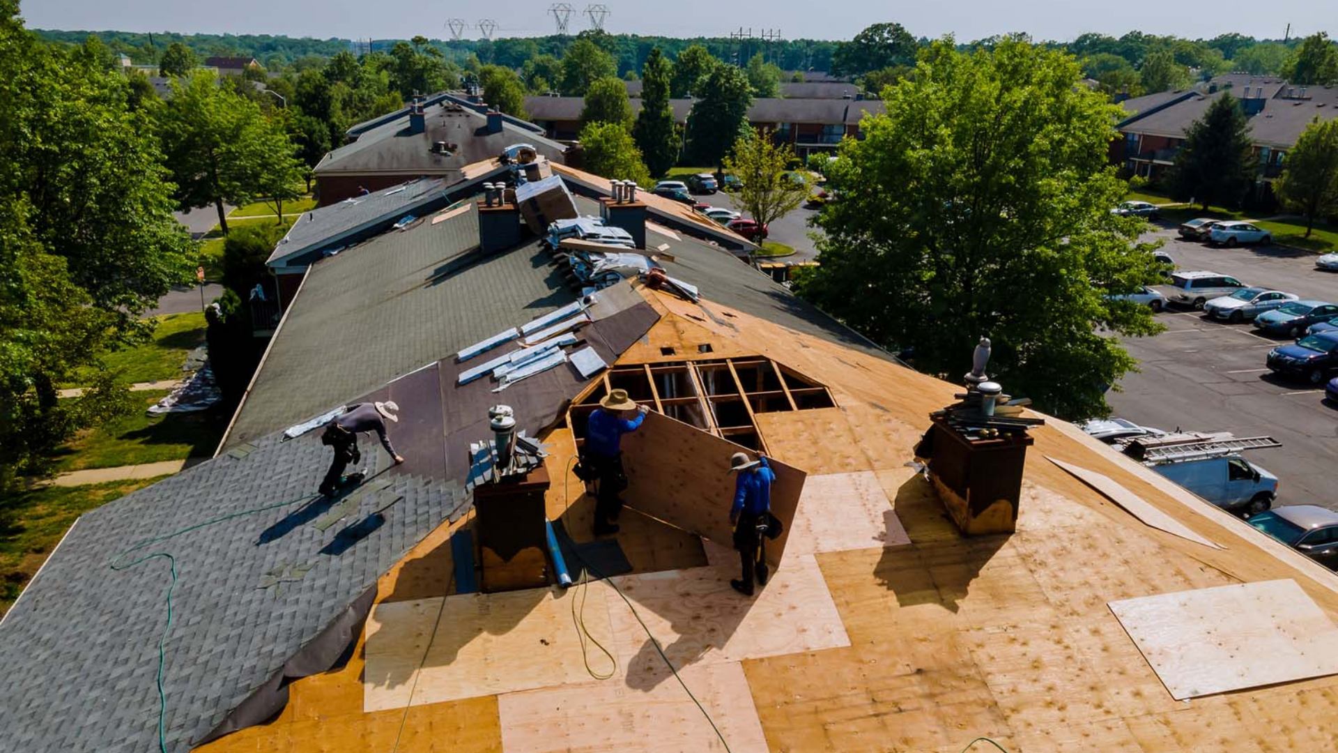 an image of a team of roofing contractors installing roof decking