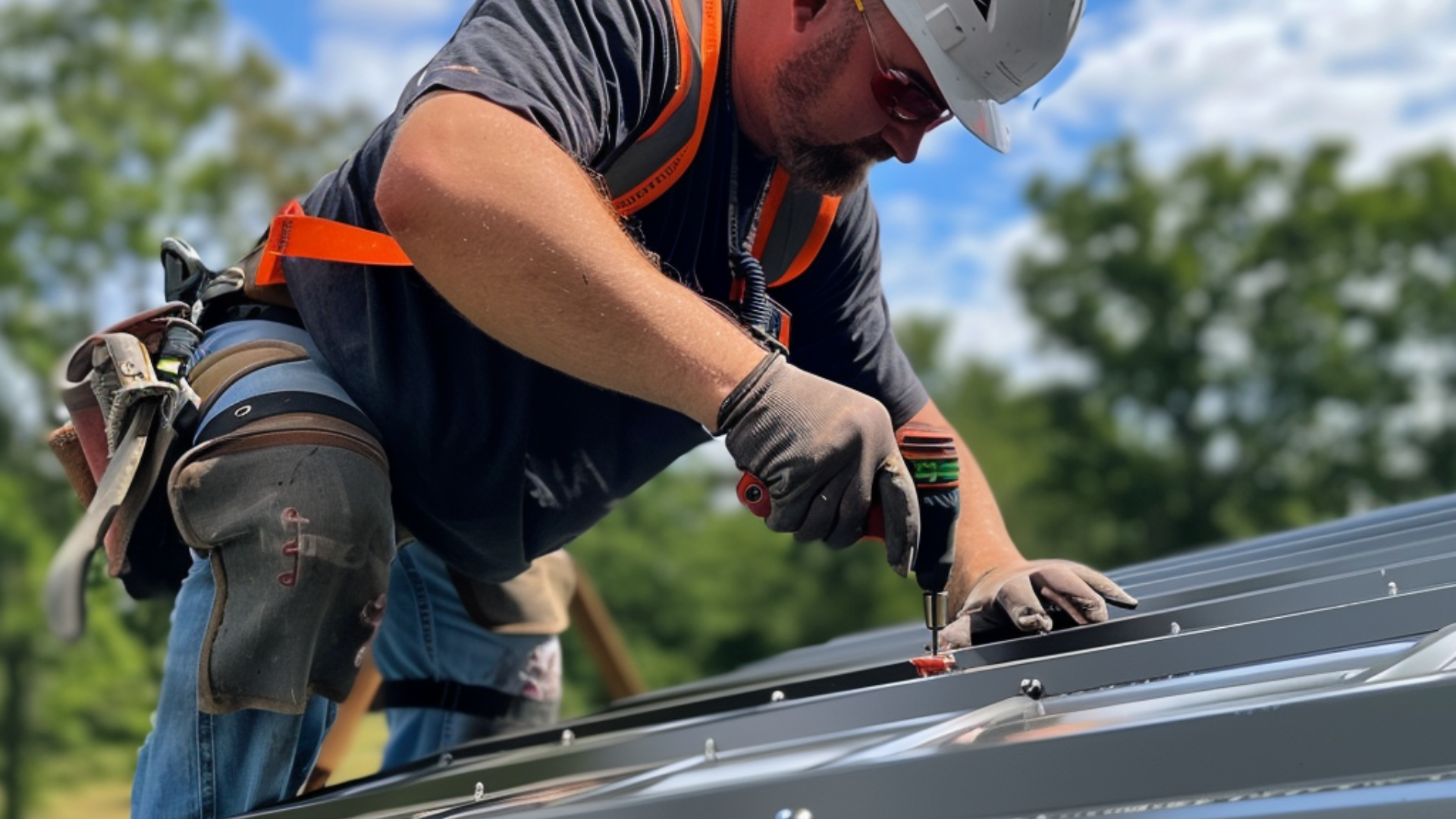 Roofer is doing a residential metal roof installation. he is drilling washer head roofing screw. The metal roof is clean and properly installed. The roofer is wearing the appropriate and complete safety gear.
