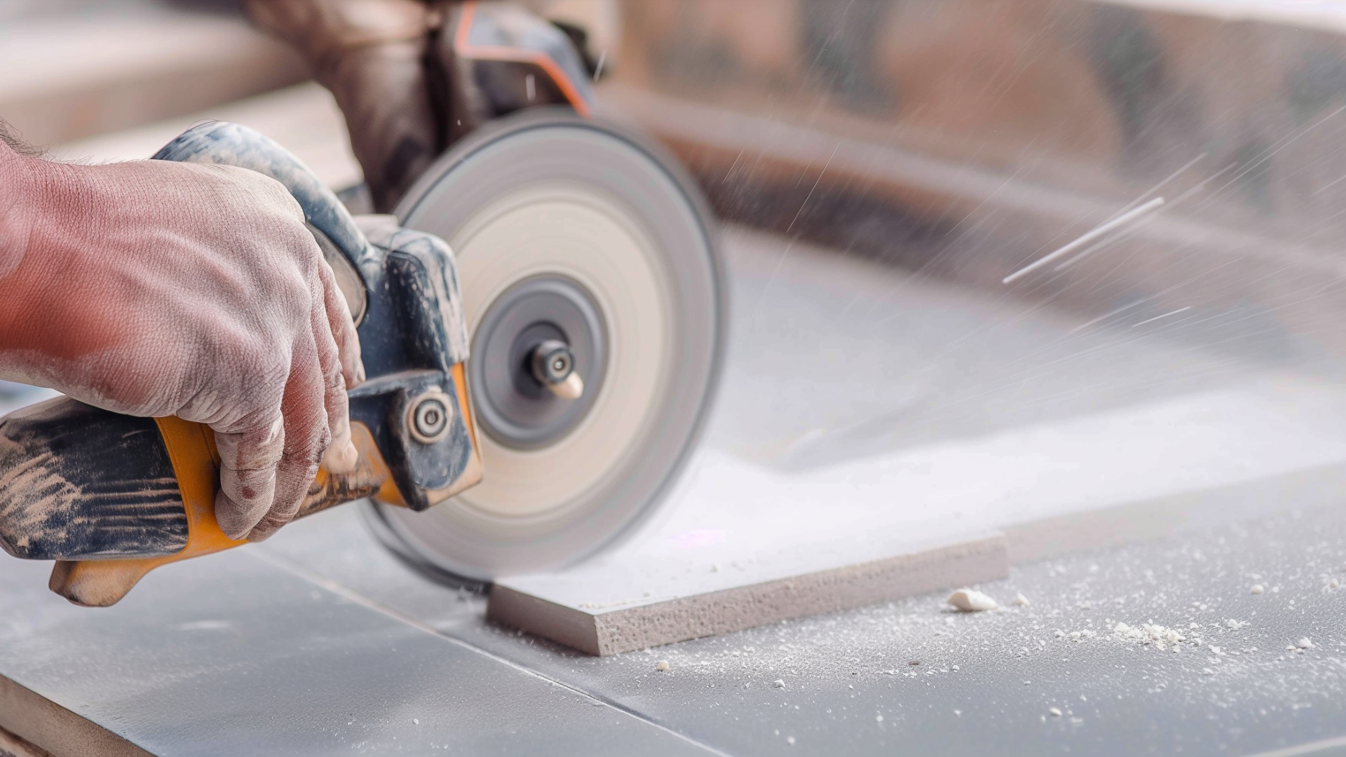 A contractor with skill saw cutting ceramic floor tile close up.