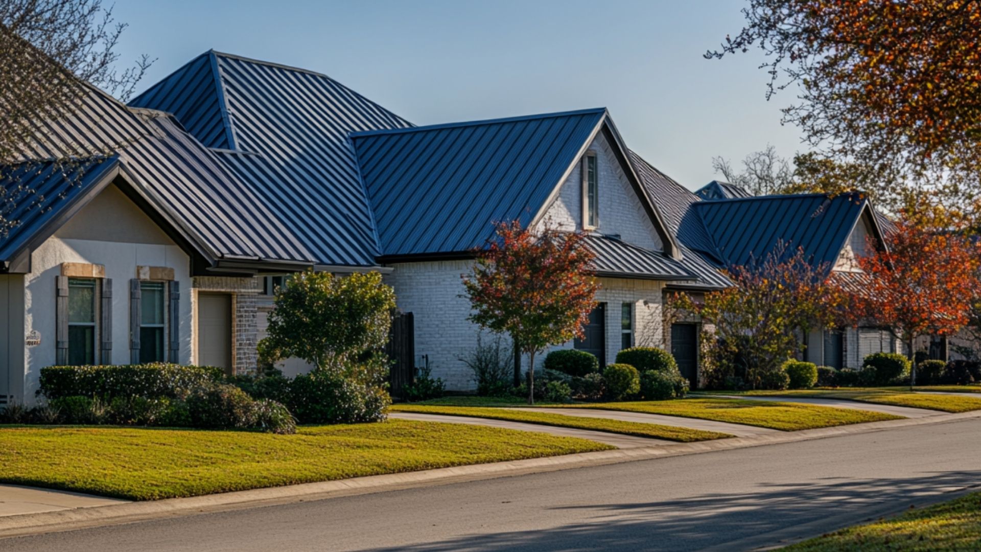 Two skilled roofing contractors, identifiable by their white hard hats and high-visibility vests, are admiring a newly installed asphalt shingles roof on a picturesque suburban home .